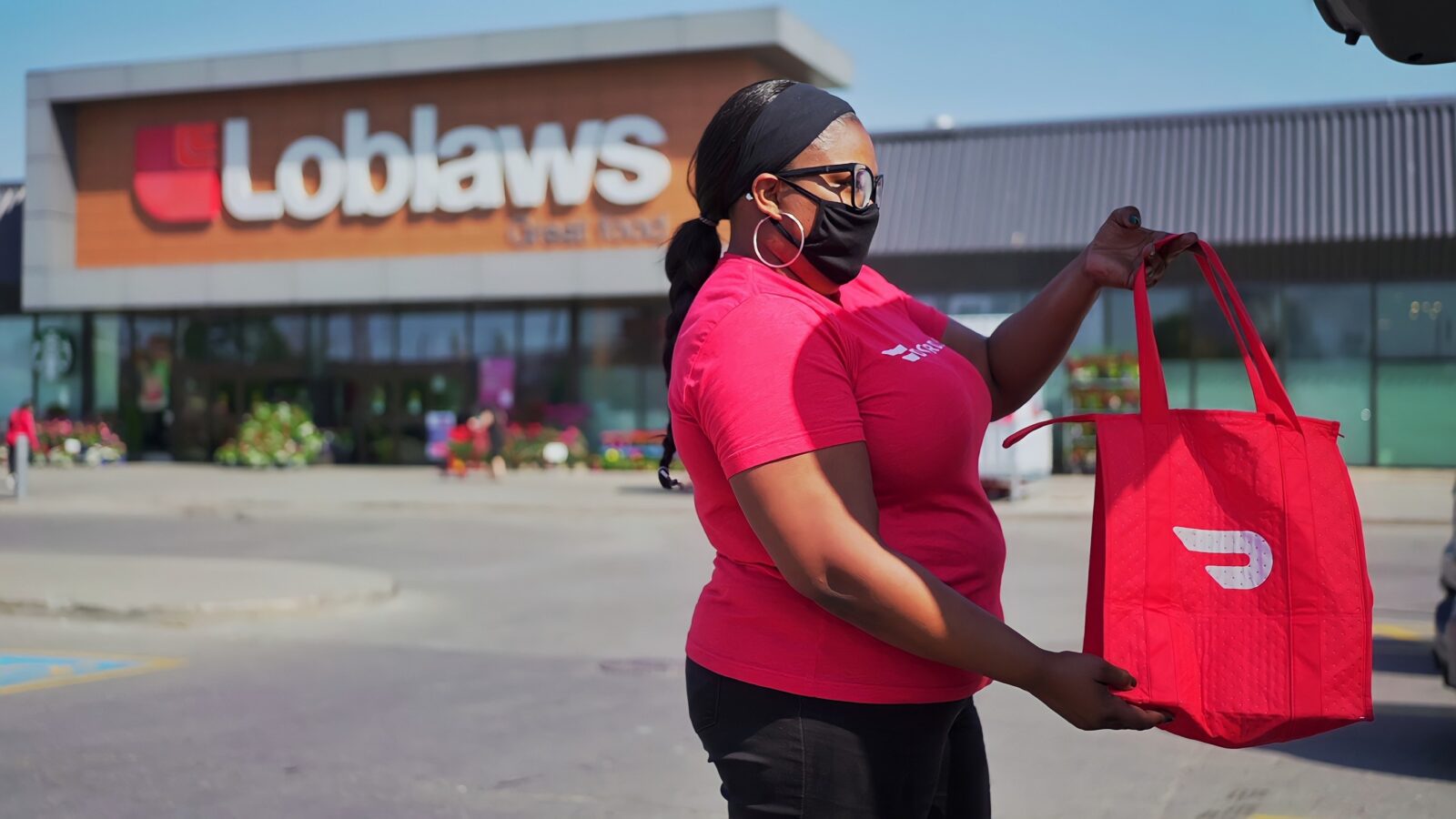 A woman working for DoorDash PC Express Rapid Delivery.