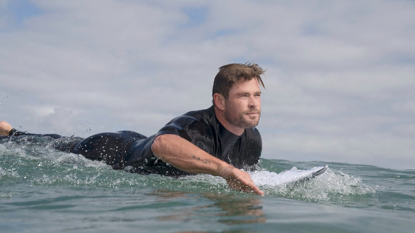 Chris Hemsworth paddleboarding in the water in Limitless with Chris Hemsworth