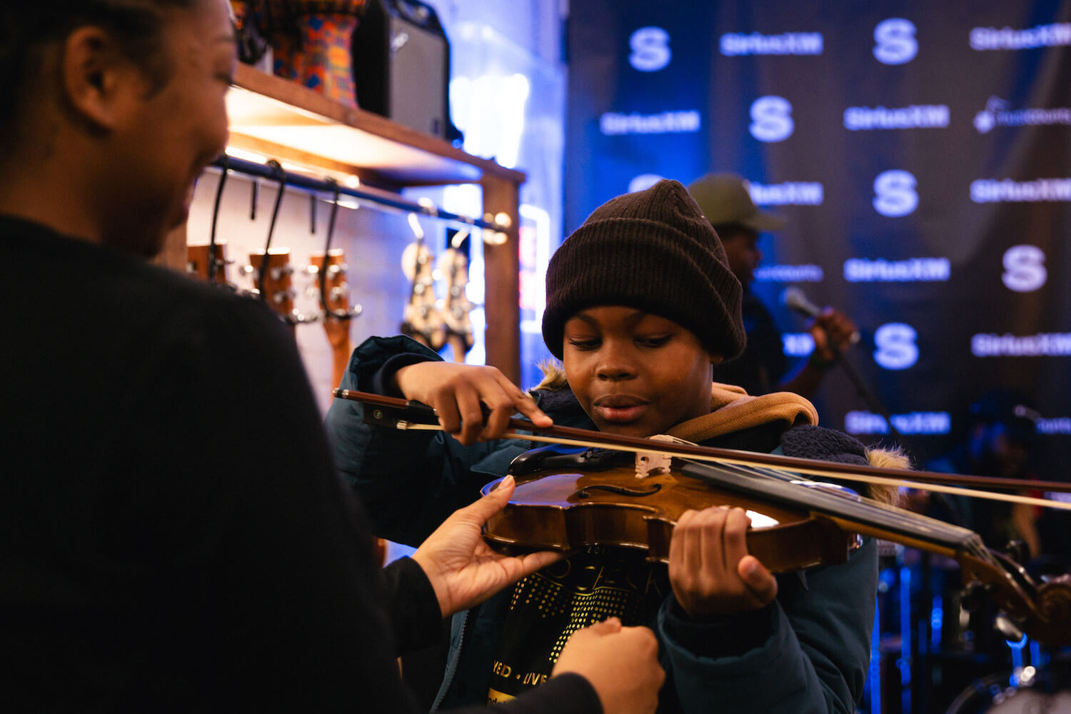 A child playing the violin at the SoundWaves Music Store