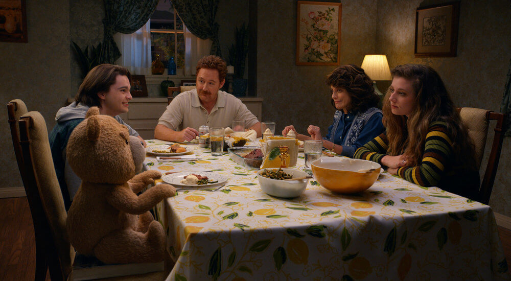 The Bennett family at the dinner table in a scene from Ted on Peacock.