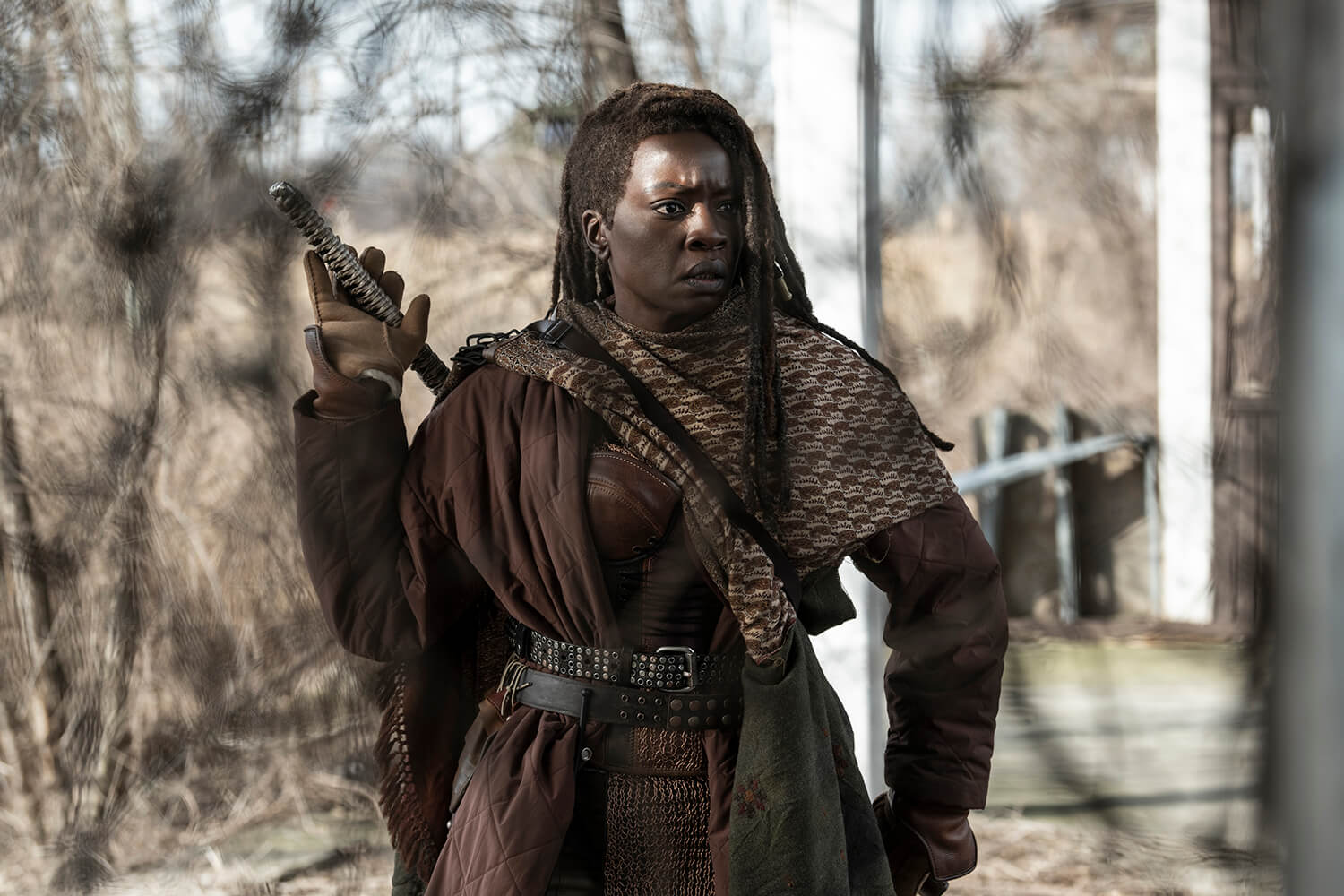 Michonne in the forest, hand on her katana in a scene from The Walking Dead: The Ones Who Live.