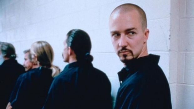 Edward Norton standing in a line of prisoners in American History X.
