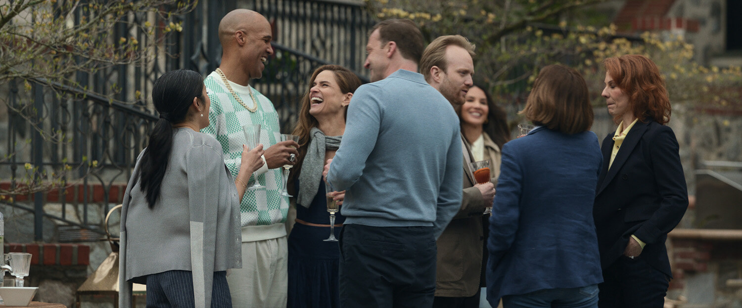 People talking outside at a fancy party in Your Friends and Neighbors.