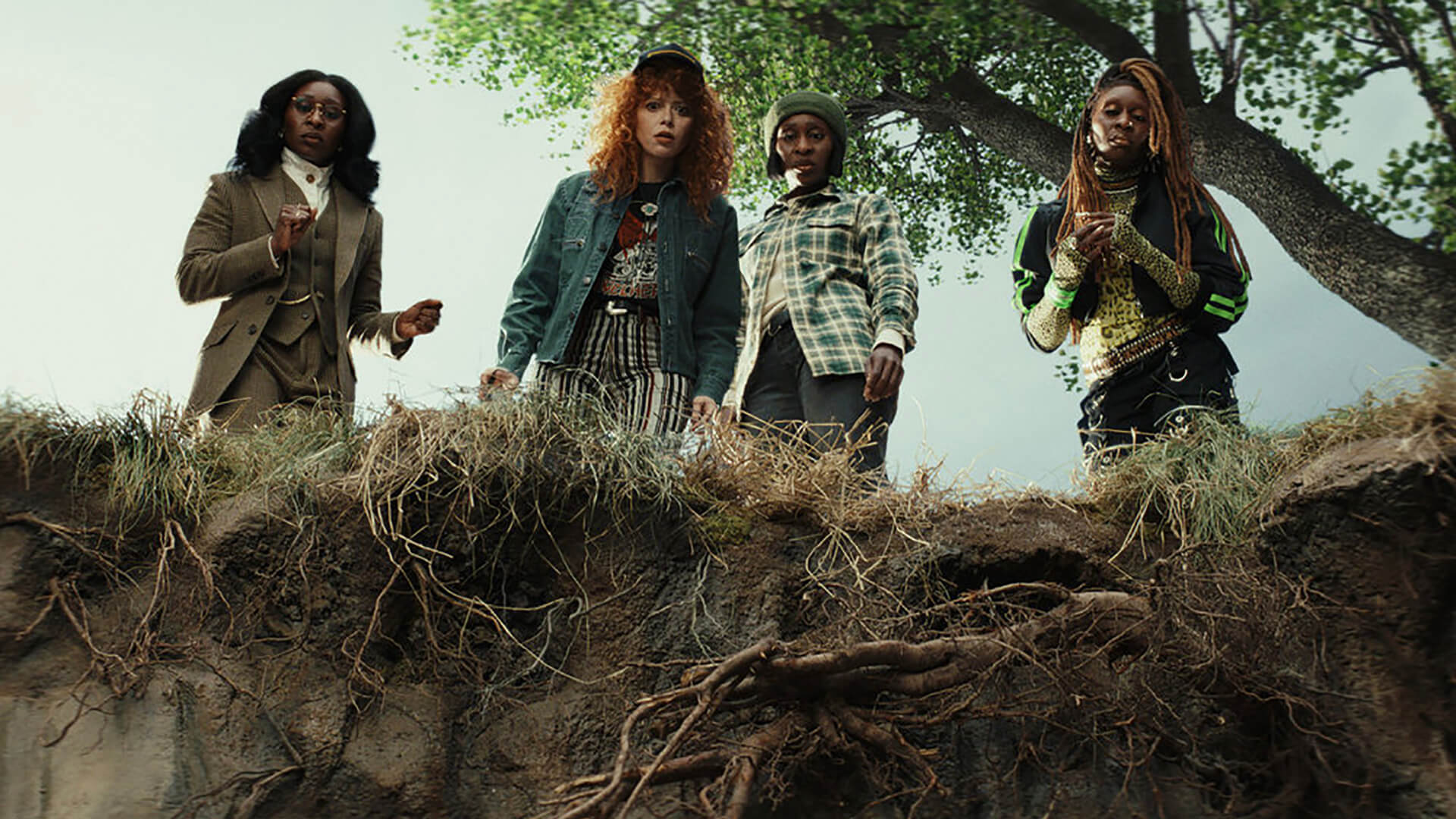 Charlie with three sisters looking over a cliff in Poker Face.