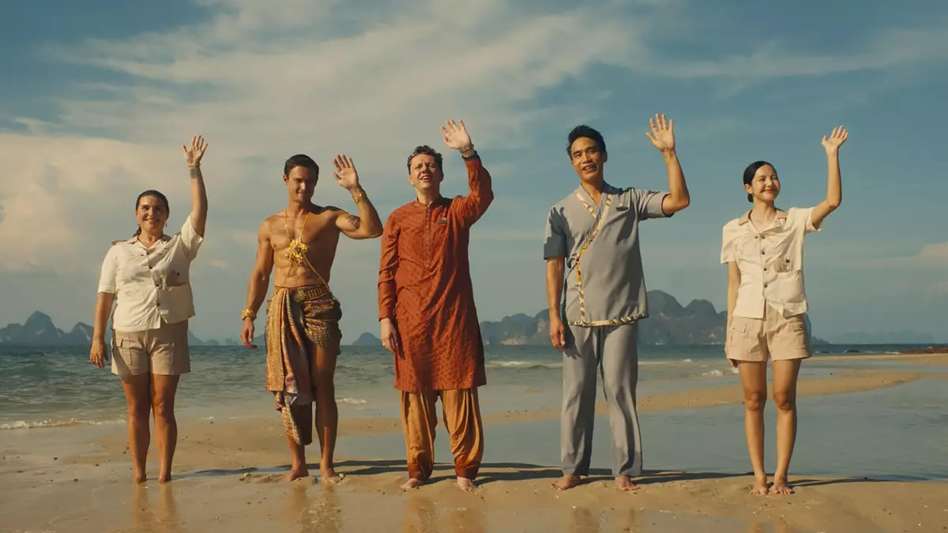 The staff at The White Lotus in Thailand wave to guests arriving by boat.
