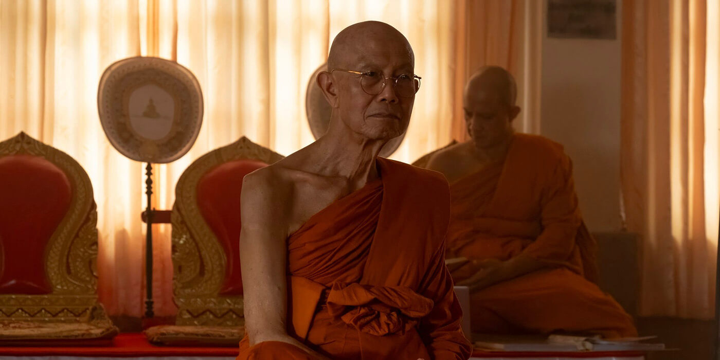 A monk sits cross-legged in The White Lotus.