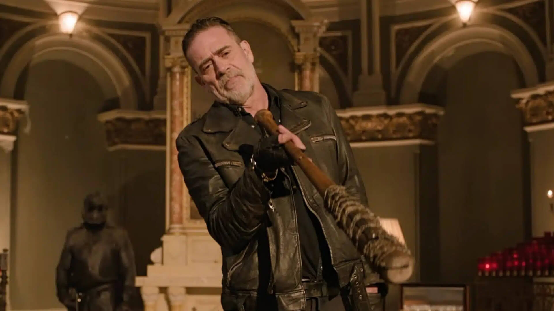 Negan hold out a barbed wire bat in The Walking Dead: Dead City.