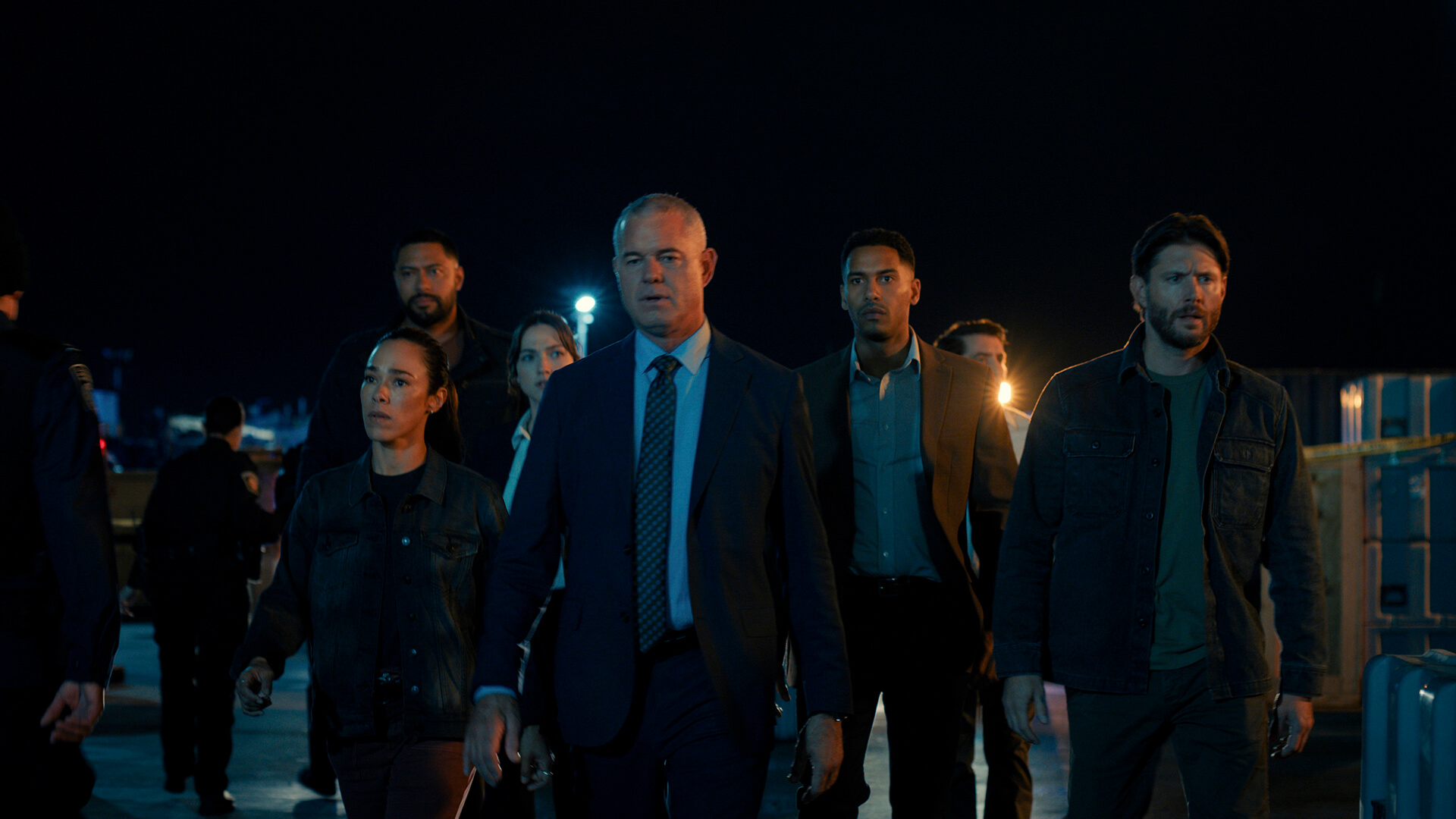 The group from Countdown stands in the dark.