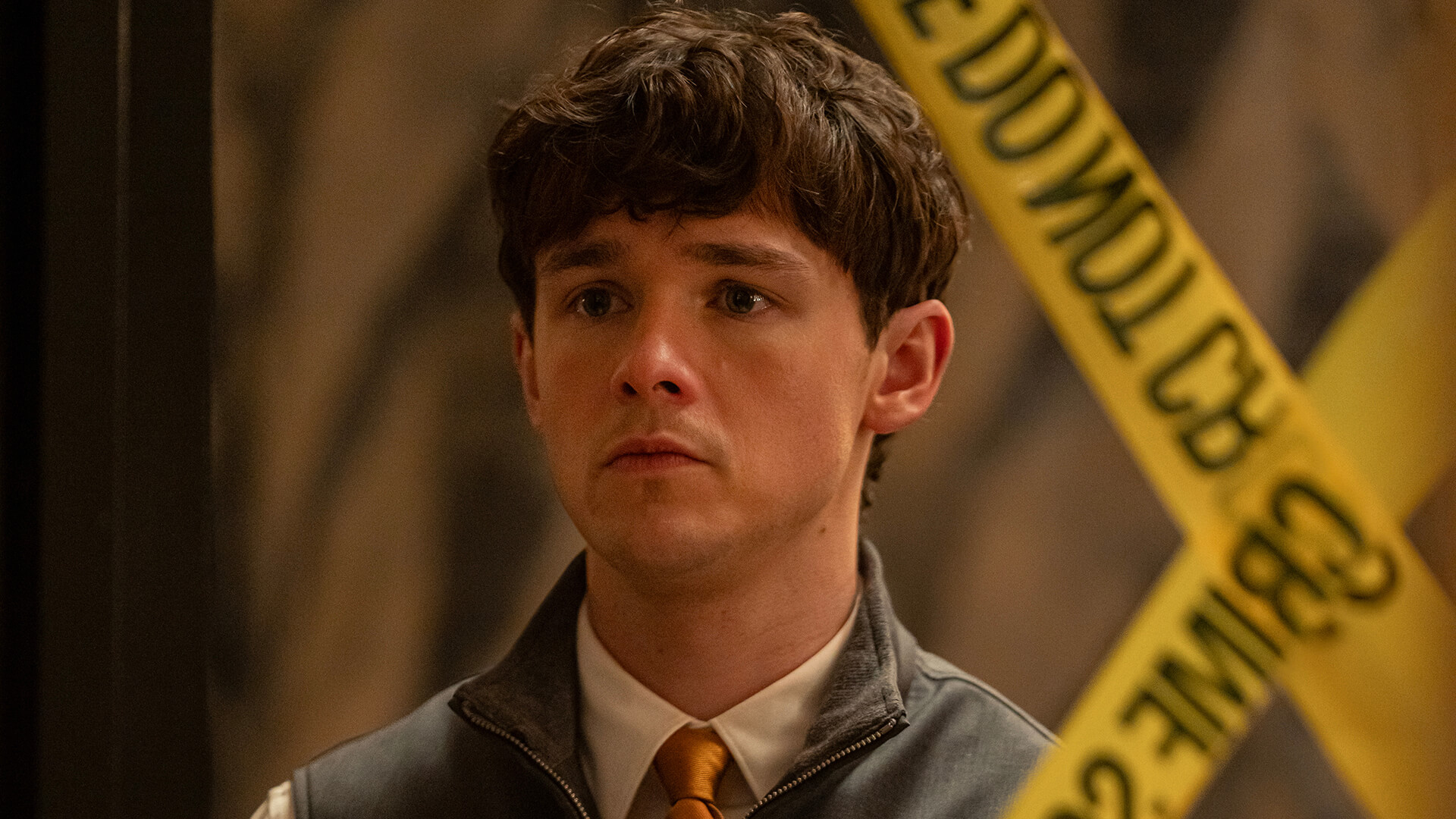 Harrison looking scared, standing by caution tape in Dexter: Resurrection.