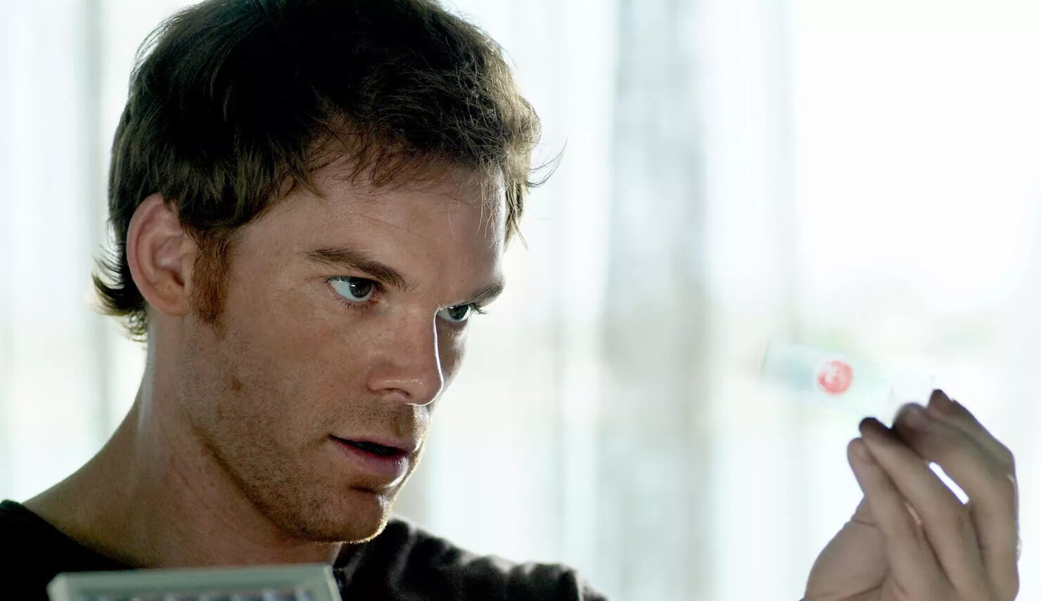 Dexter looking at one of his blood slides.