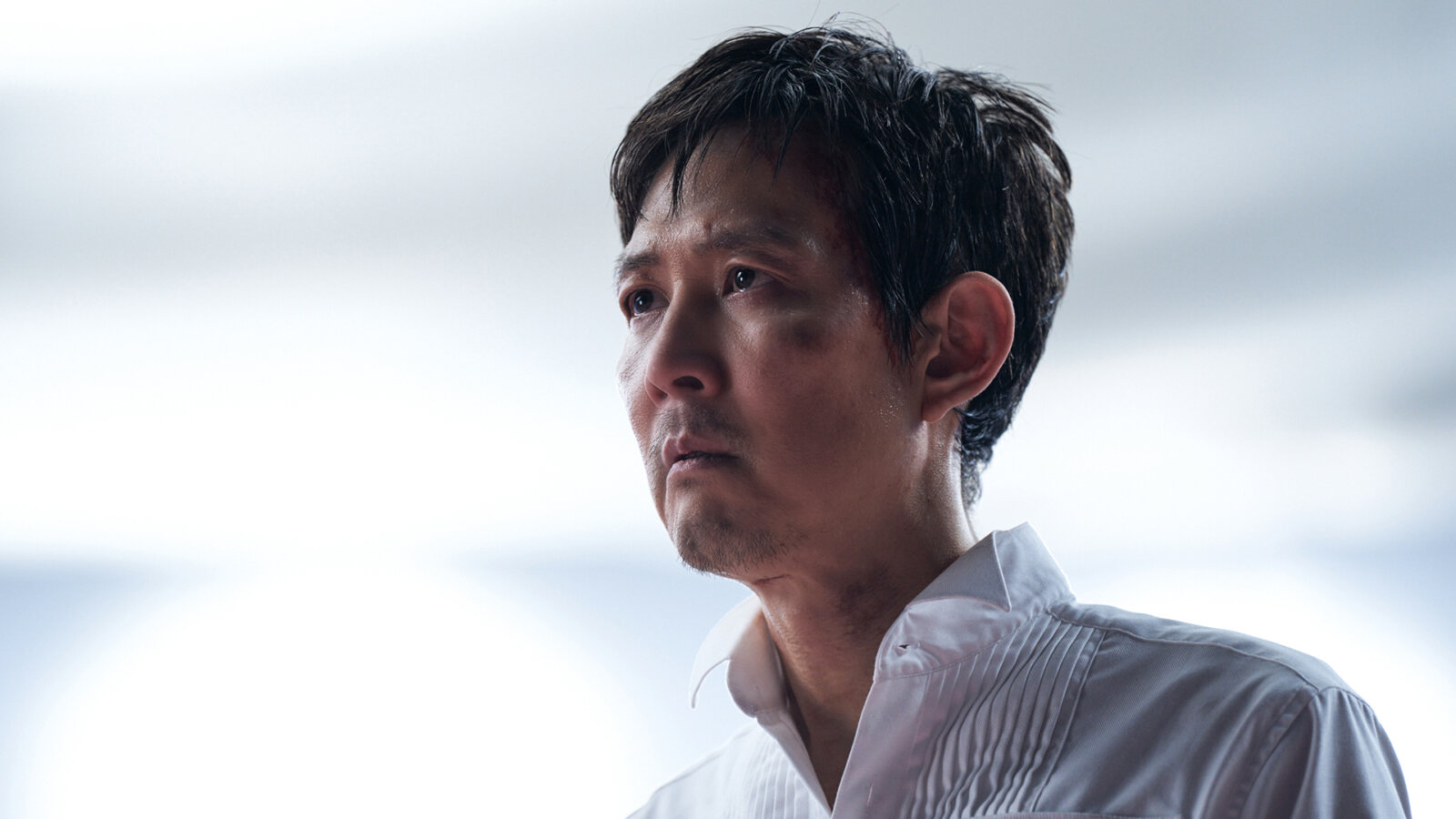 Gi-hun in a white button shirt in Squid Game.
