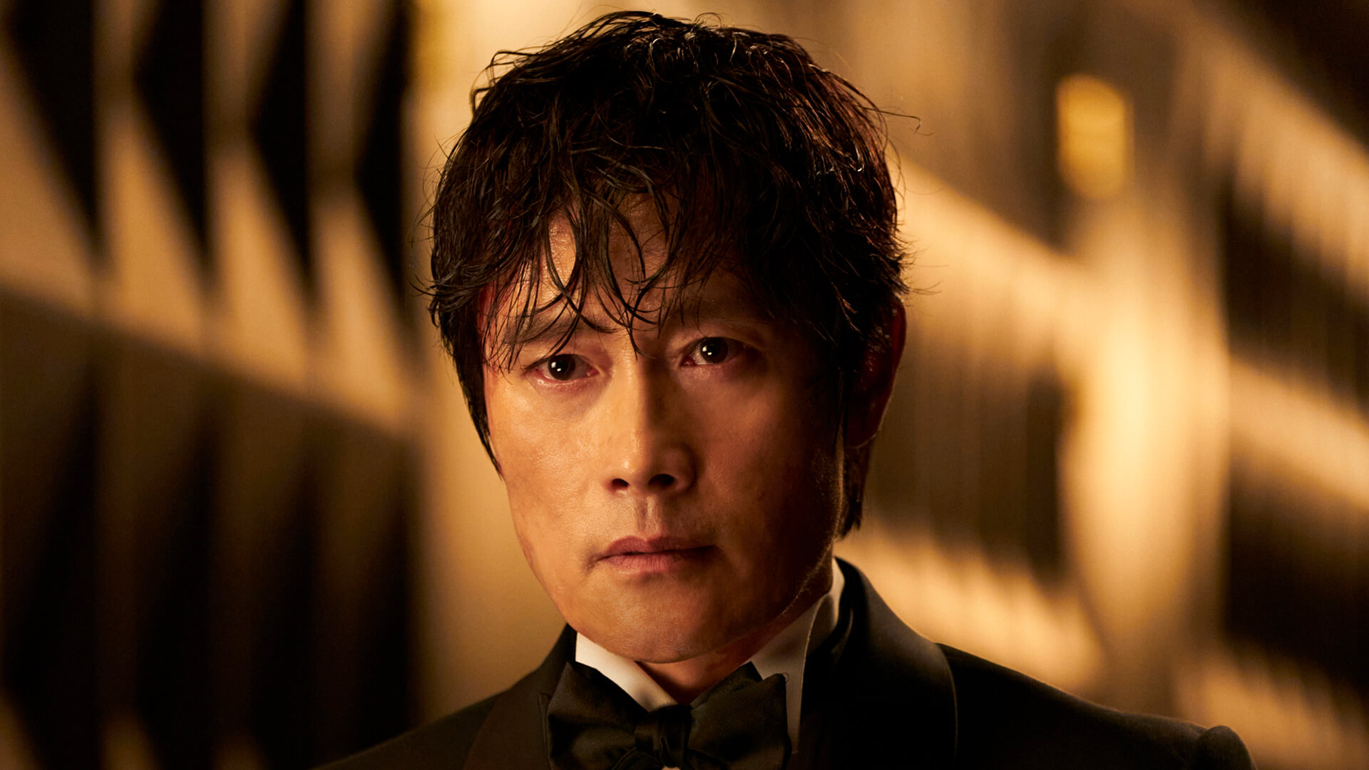 The Front Man in a suit in Squid Game.