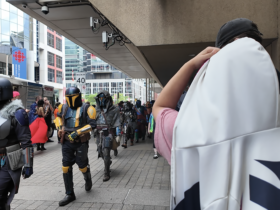 People in costume walking into Fan Expo Canada.