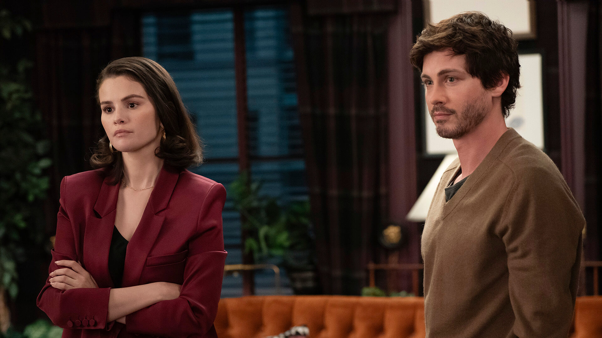 Mabel standing with a young man in Only Murders in the Building.