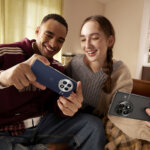 Two young people with OnePlus 13 phones