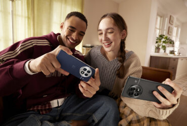 Two young people with OnePlus 13 phones