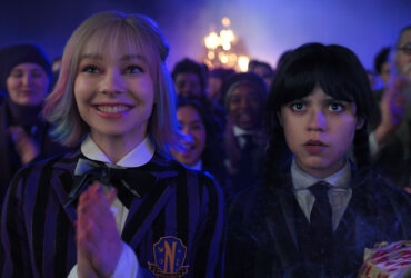 Enid and Wednesday standing in front of others in Wednesday.