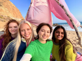 A group taking a selfie with an iPhone 17
