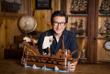 Ke Huy Quan with The Goonies Lego set.