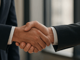 Two men in suits shaking hands.