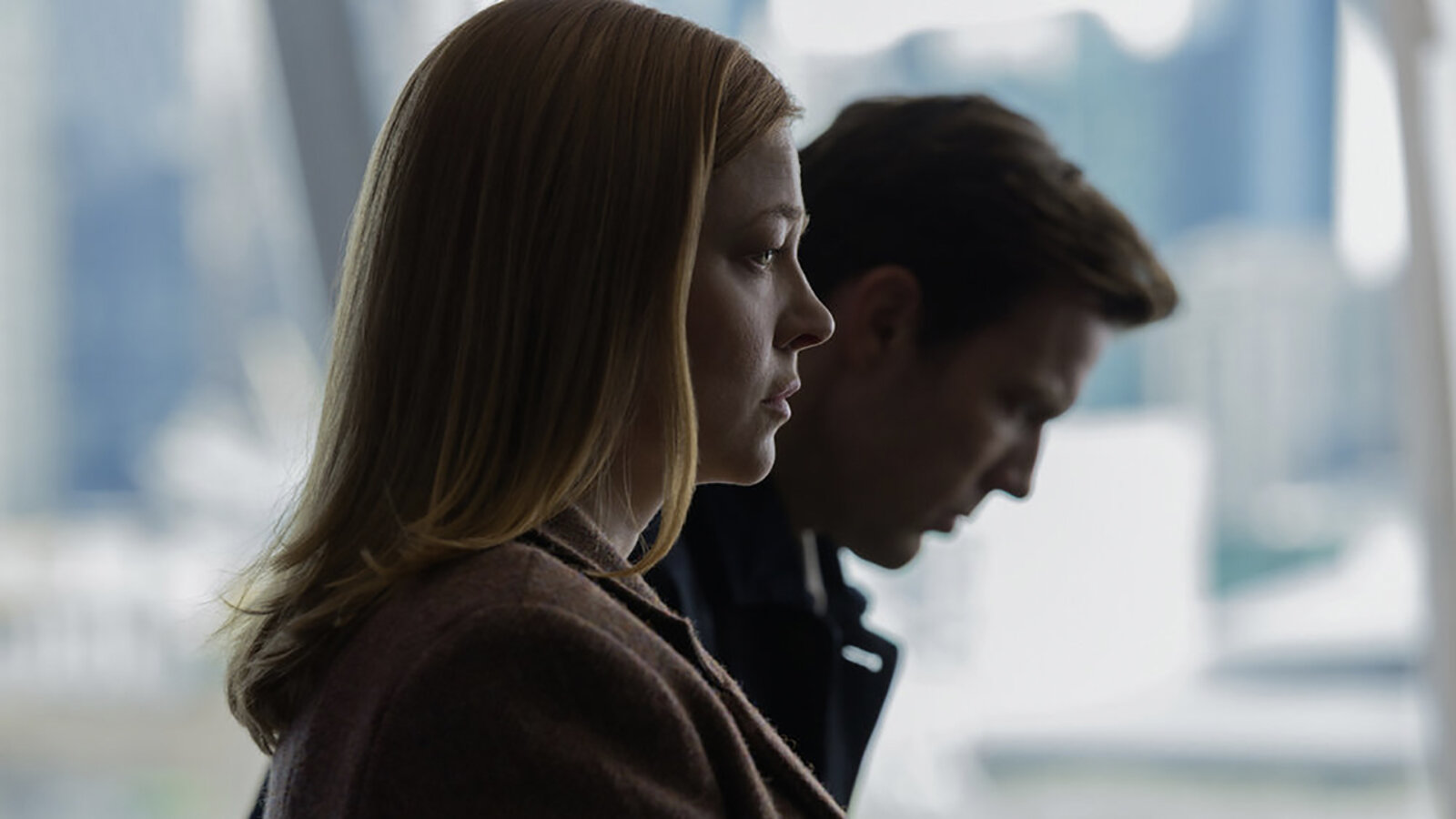 A woman and man looking upset in side profiles in All Her Fault.