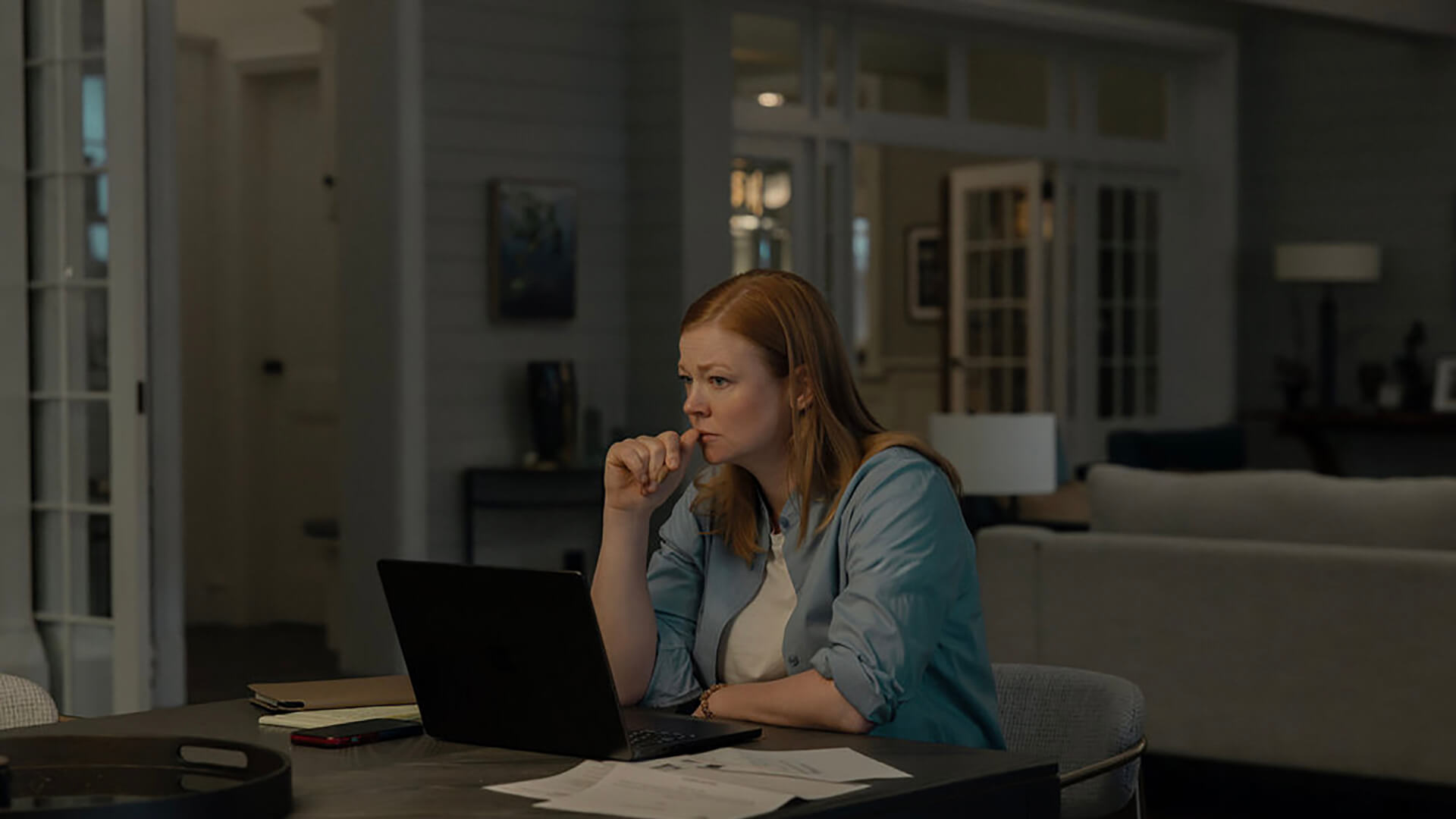 Marissa sitting behind the computer in All Her Fault.