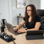 Woman sitting at a desk behind a computer