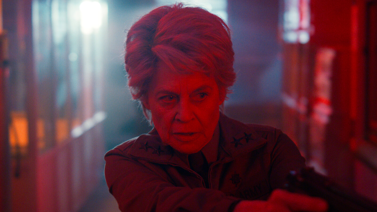 Dr. Jay pointing a gun in Stranger Things.