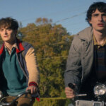 Will, Mike, and Holly riding their bikes in Stranger Things.