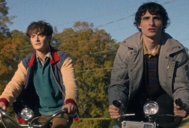 Will, Mike, and Holly riding their bikes in Stranger Things.