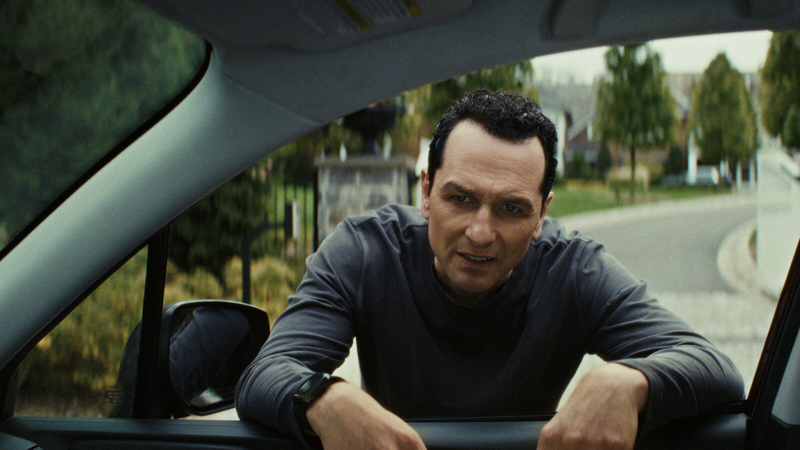 Nile standing at Aggie's car window in The Beast in Me.