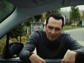 Nile standing at Aggie's car window in The Beast in Me.