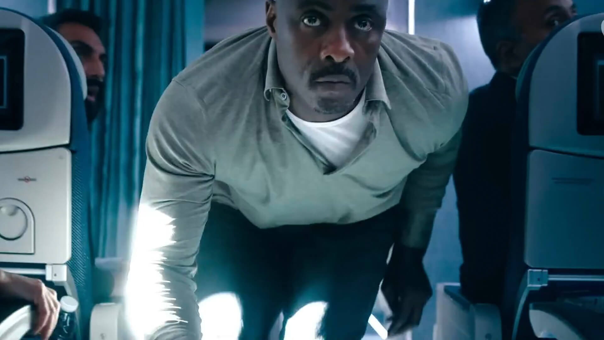 Sam crouched down in the plane in Hijack.