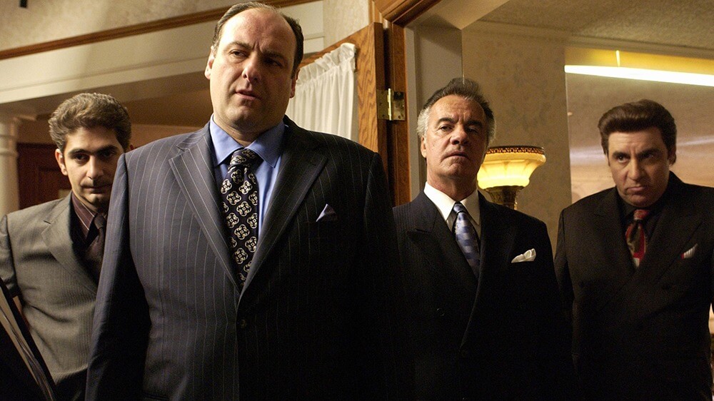 Four men stand in suits in The Sopranos.