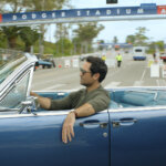 A side view of Mickey driving his car in The Lincoln Lawyer.