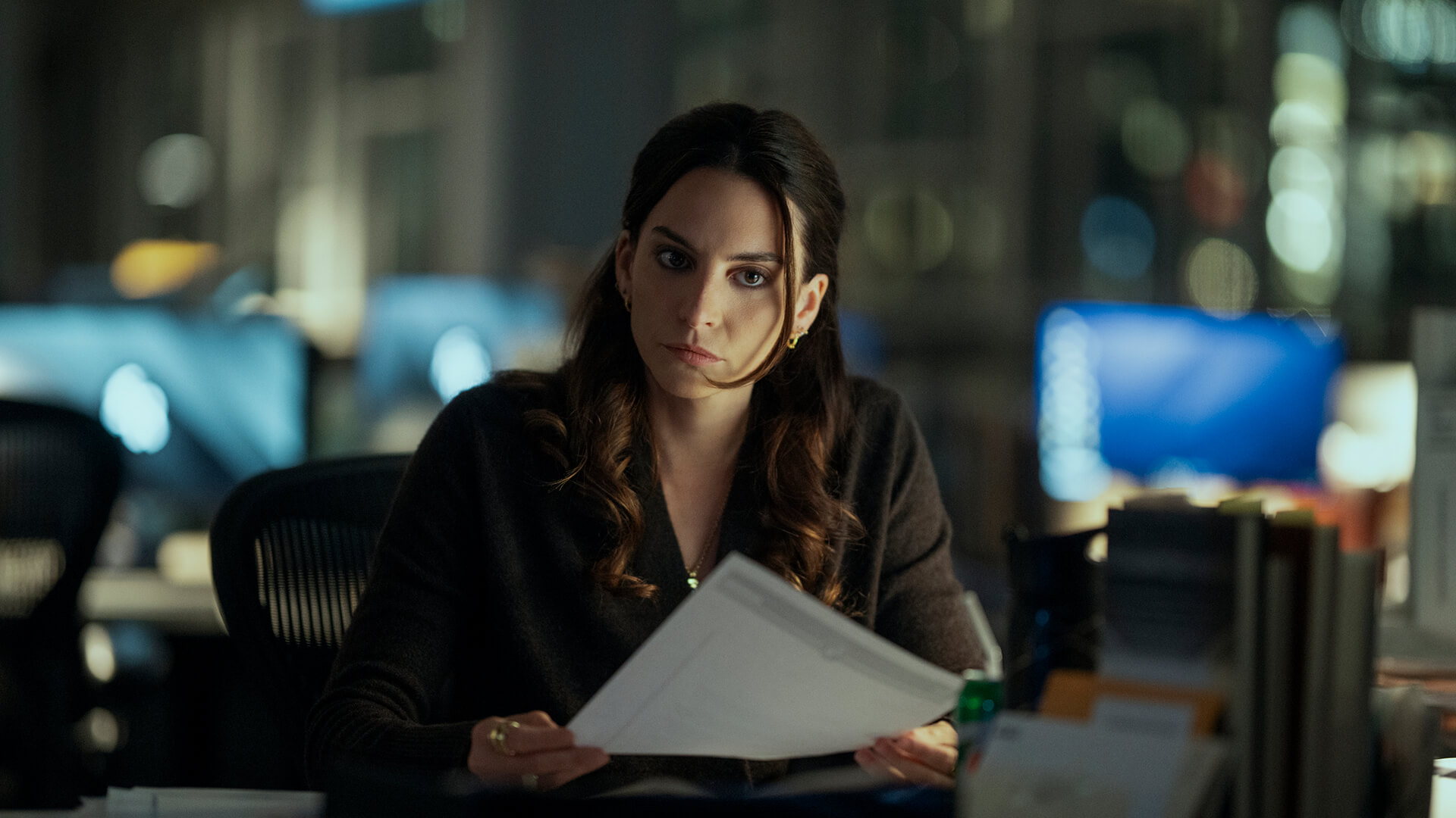 Isabel at her desk with papers in The Night Agent.