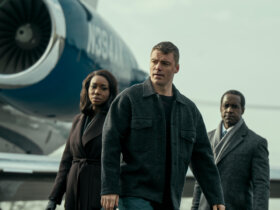 Peter with his handlers standing by a plane in The Night Agent.