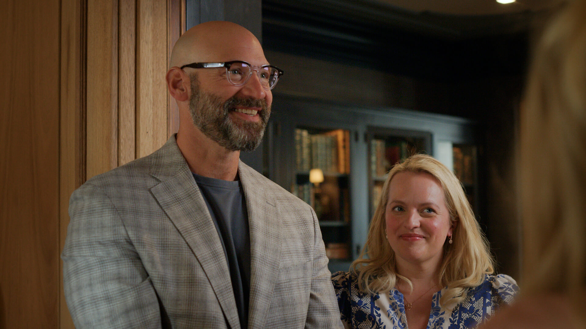 A man and woman greeting someone at the door in Imperfect Women.