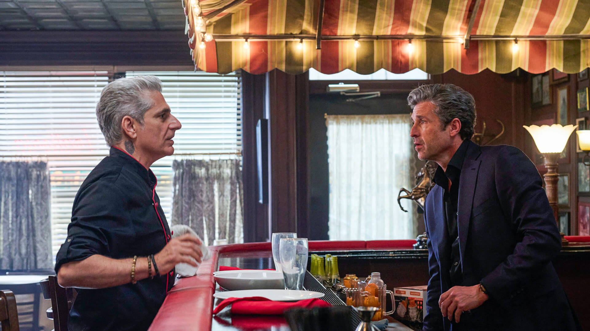 Angelo and Dutch talking in the restaurant in Memory of a Killer.