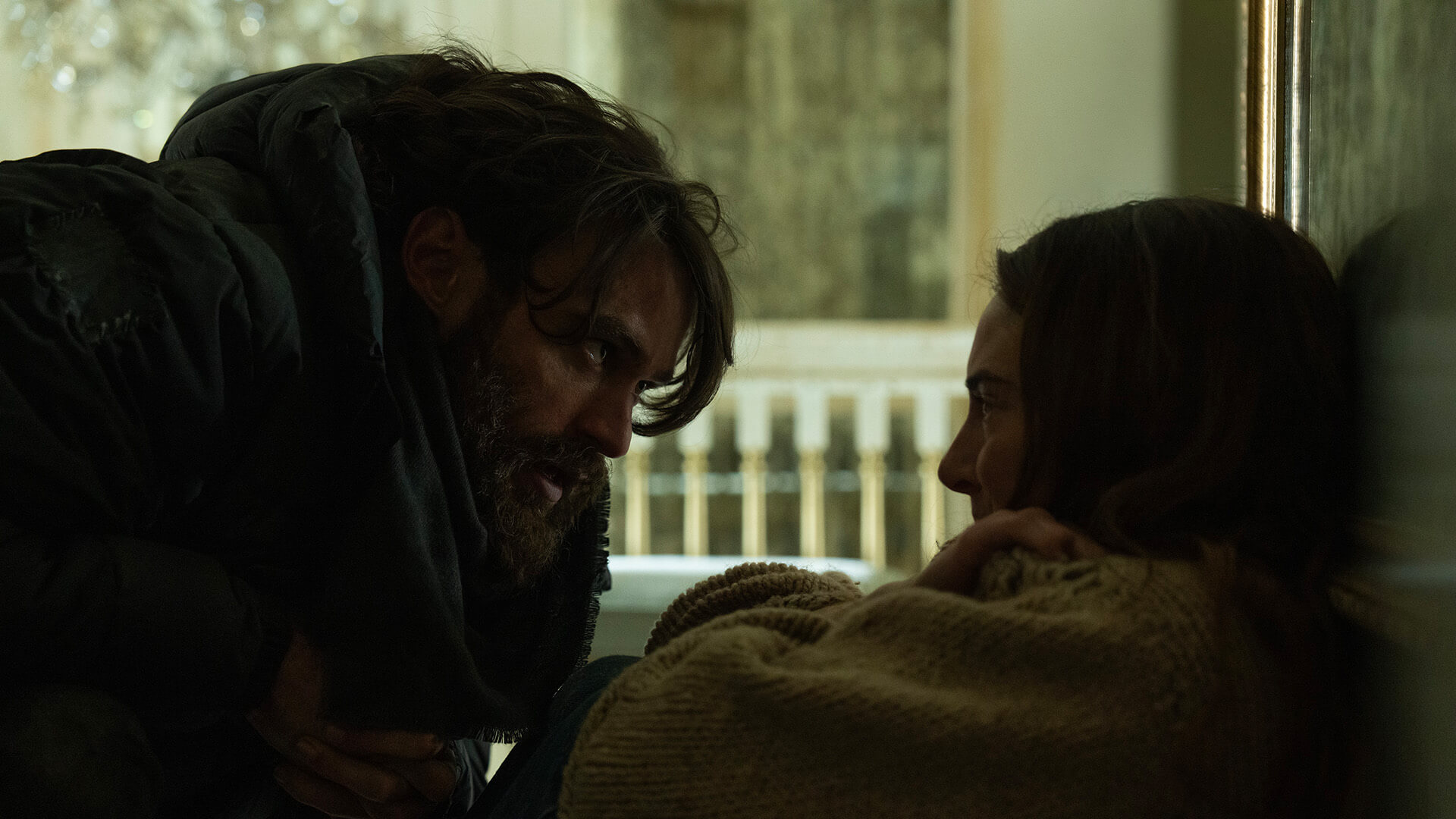 A man confronting a woman cowering on the floor in Paradise.