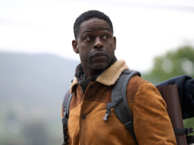 Xavier walking outside with a backpack in Paradise.