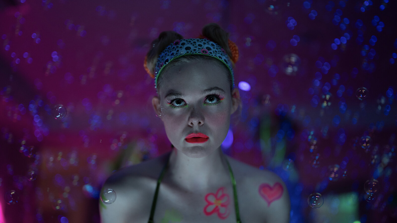 Margo in make-up o a psychadelic background in Margo's Got Money Troubles.