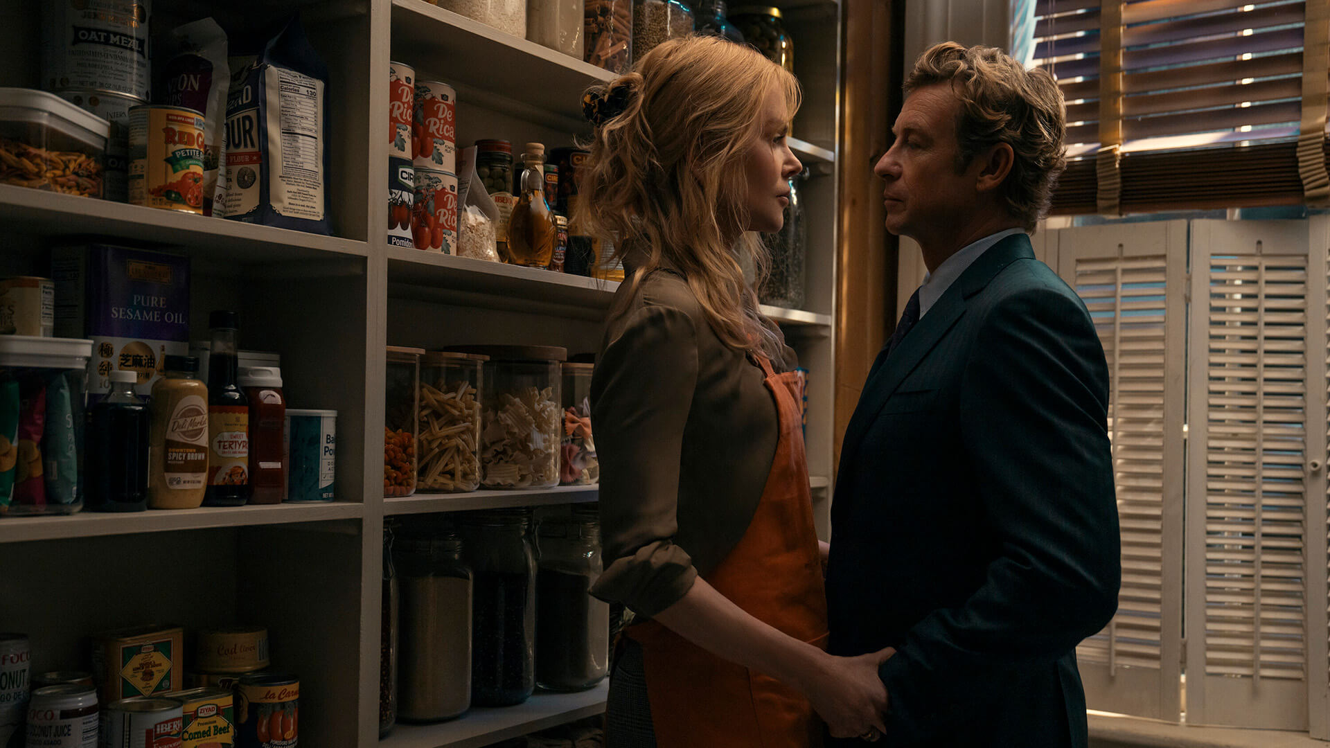 Kay and Benton embracing in the pantry in Scarpetta.