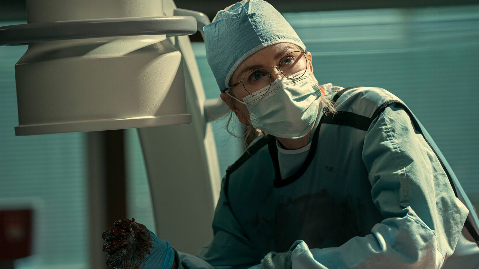 Kay with scrubs and a mask on in Scarpetta.