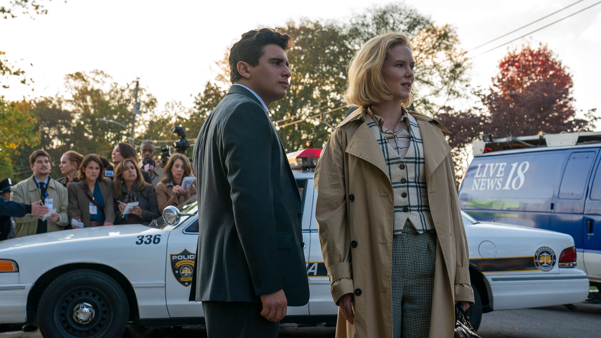 Young Pete and Kay standing by a police car in Scarpetta.