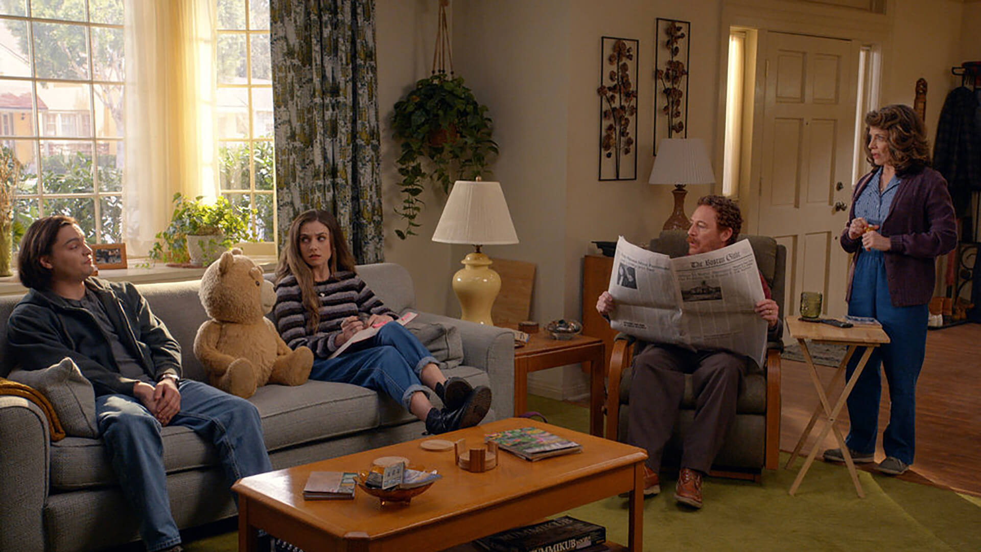 The family sitting around the living room in Ted.