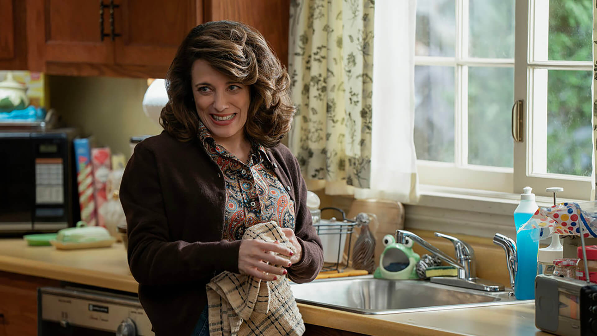 Susan standing by the sink in Ted.