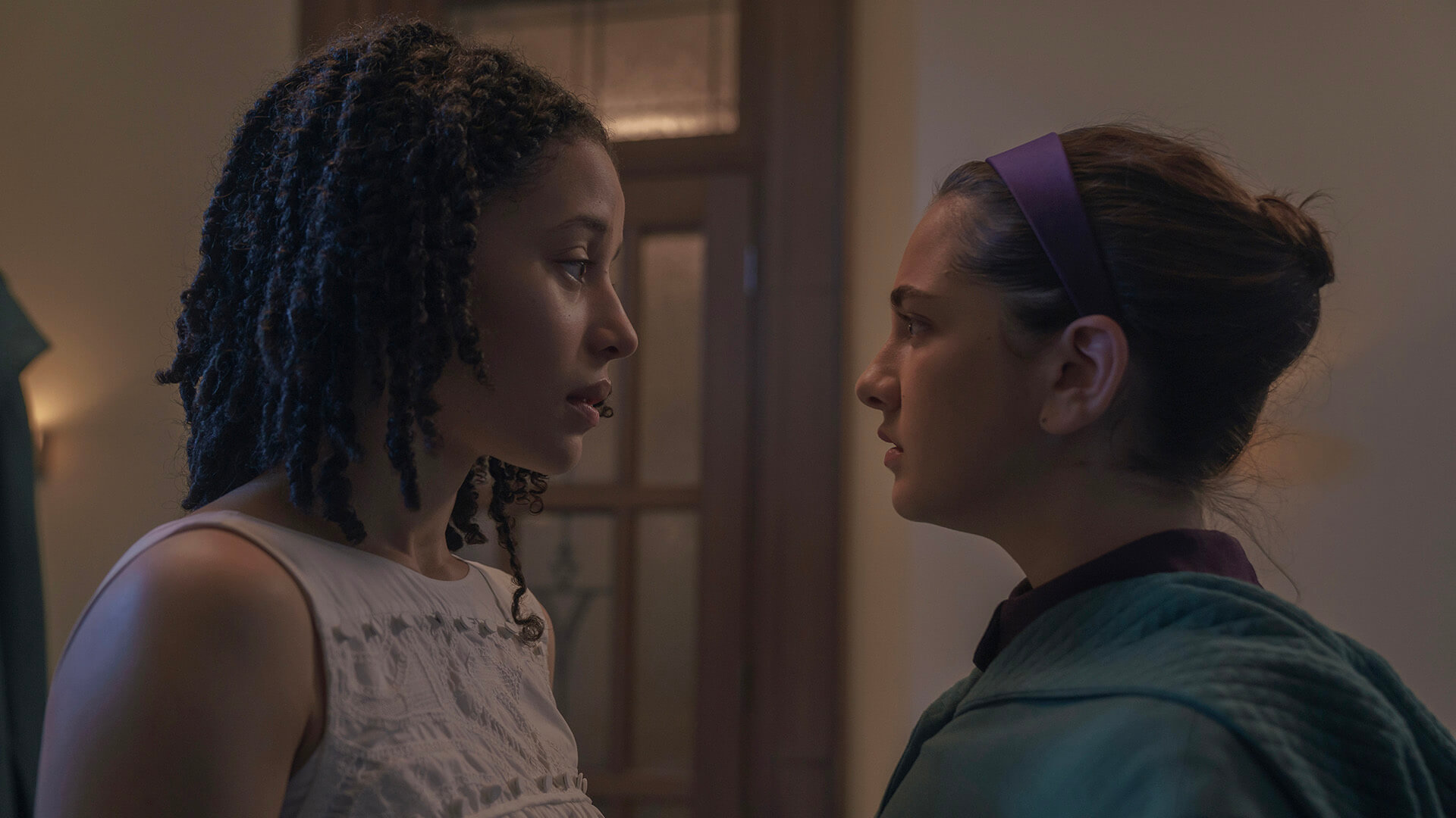 Agnes ad Becka looking at one another in The Testaments.