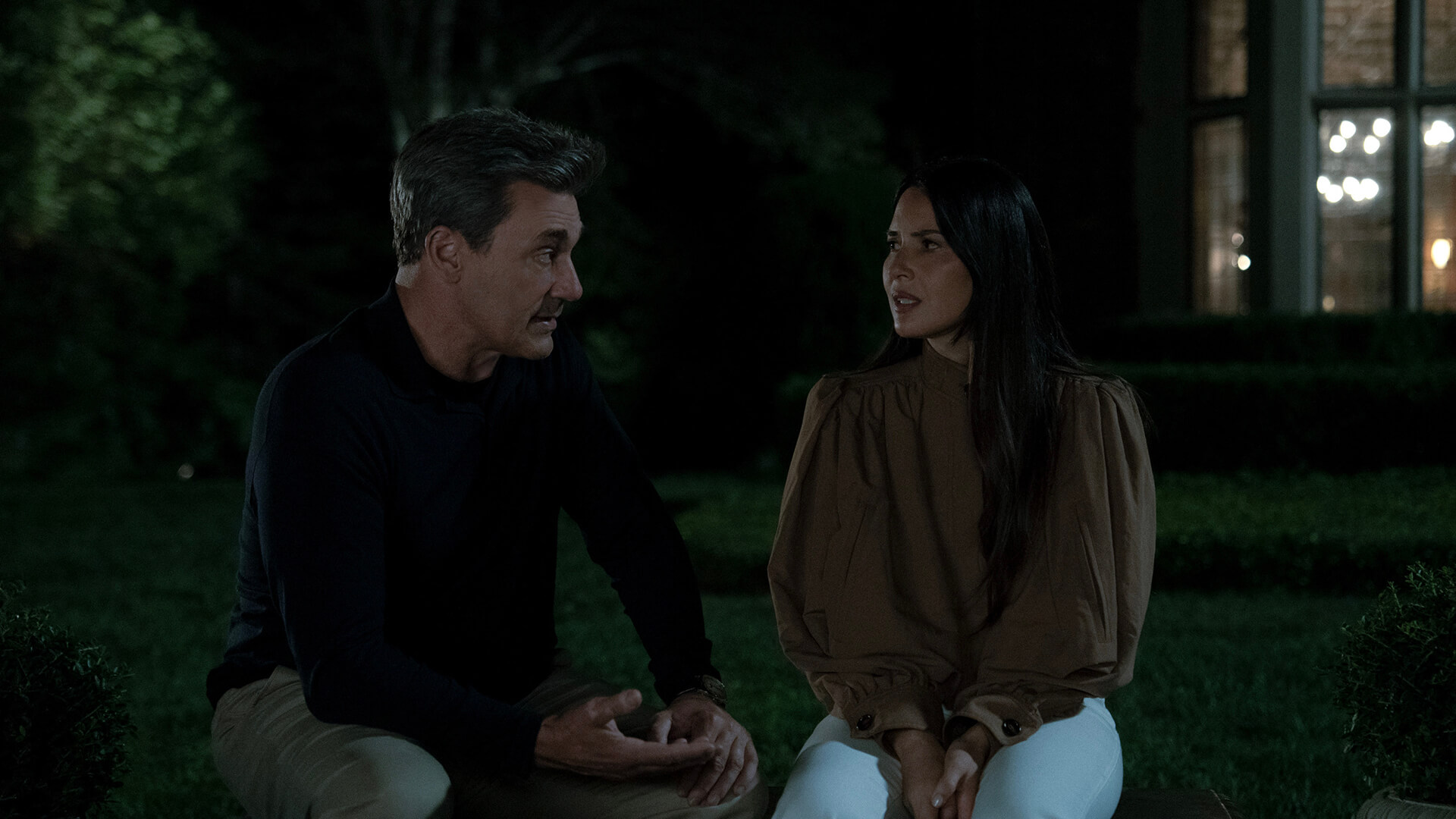 Coop and Sam sitting outside in the dark talking in Your Friends & Neighbors.