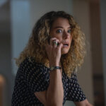 Paula on the phone looking shocked in Maximum Pleasure Guaranteed.